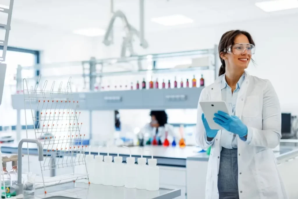 Female scientist holding a digital tablet in a clean modern chemistry laboratory