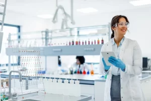 Female scientist holding a digital tablet in a clean modern chemistry laboratory